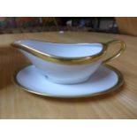 A boxed Legle Limoges, porcelain white and gold-rimmed gravy boat, 7 x 21cm, and matching dish, 15 x