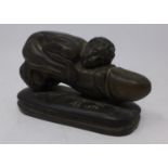 A bronzed resin erotic figure, signed AB 1876, H.10 W.16 D.8cm