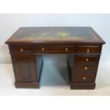 A late 19th century oak pedestal desk, with leather top and brush slides, H.76 W.123 D.68cm