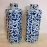 A pair of contemporary Chinese blue and white hexagonal jars, decorated with butterflies, bearing