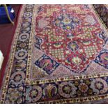 A Central Persian Isfahan carpet, double pendent medallion with repeating petal motifs on a rouge