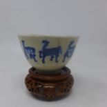 An 18th century Chinese blue & white porcelain tea cup decorated with horses, with character marks