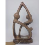 A soapstone abstract sculpture of two figures, H.39cm