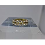 An 18ct yellow gold diamond ring composed of two graduated rows of round brilliant-cut diamonds,