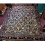 An antique Persian rug with repeating geometric motifs, worn, 208 x 155cm