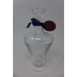 A William Yeoward cut and engraved clear glass carafe on footed base, bearing label and ribbon and