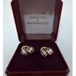 A boxed pair of 9ct yellow gold stud earrings each set with callibre rubies and brilliant-cut