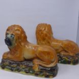 A pair of Scottish brown glazed recumbent lions, H.26 W.33 D.15cm