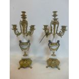 A pair of Italian Brevettato brass, gilt metal and white marble candelabras each bearing 7