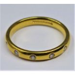 An 18ct yellow gold ring set with 5 round, brilliant cut diamonds, Size: M, 4g