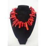 A large natural red coral bead necklace composed of 38 natural coral beads to a sterling silver