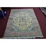 An antique part silk Tabriz carpet, the central floral medallion surrounded by floral motifs, on a