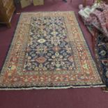 A North West Persian Mahal rug, repeating stylised floral motifs on a sapphire field, within