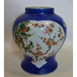 A 19th century Chinese porcelain vase, with flora and fauna panels, on a blue ground, with