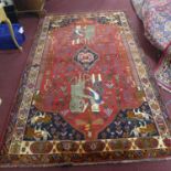 A West Persian Qashqai carpet, central diamond medallion with the guard and lion on either side on a