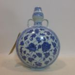 A Chinese, 20th century, hand-painted blue and white moonflask with twin handles decorated with