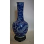 An early 19th century Chinese blue and white vase, decorated with four clawed dragons chasing