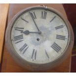An early 20th century circular wall clock with a white-painted circular metal dial with black