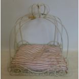 A wrought iron, cream-painted dog's bed with feather-filled cushion in striped cotton fabric, H: