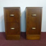 A pair of Art Deco figured mahogany pedestal chests, having two small drawers with Bakelite handles,