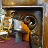 A 19th century Chinese hardwood altar table, scrolling floral carving to front panel, with single