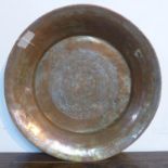 A Middle Eastern copper charger, with engraved geometric design to centre, Diameter 48cm