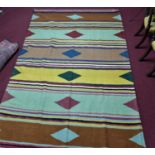 A Southwest Persian Qashqai kelim rug bearing repeating stylised diamond medallion on stripes of