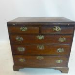 A 19th century mahogany chest of two short over three long drawers, with brushing slide, raised on