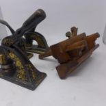 Three floral painted metal embossing stamps, together with a antique wooden plane, (4)