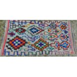 A vintage Moroccan Berber Azilal rug, with multi-coloured diamond medallions, 158 x 76cm