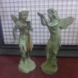 Two cast iron fairies in the verdigris finish, one holding a bird, and the other holding a lily, H.