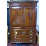 An inlaid mahogany linen press, with two cupboard doors above an arrangement of seven drawers, on