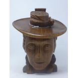 A carved oak scultpure of a lady in a large-brimmed hat in 19th century dress, possibly American