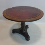 A circular occasional table on turned floral carved supports, on tri-form base and bun feet, with