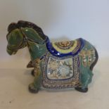 A Chinese ceramic horse, polychrome decorated with flowers, H.30 L.40cm