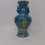 A Chinese, Ming-style blue glazed vase hand decorated with figures on a terrace and floral motifs,