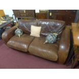 A tan leather two seater sofa