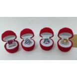 Four boxed white metal and gem-set rings set with mystic topaz, blue enamel and crystals (2