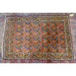 A 20th century fine north west Persian Bidjar carpet, with repeating floral motifs, on a salmon pink