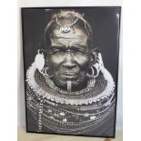 A large framed print of an tribal man, 140 x 100cm