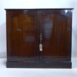 An Edwardian inlaid mahogany linen press cupboard, the two doors enclosing 3 linen trays above two