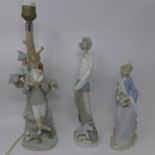 A Lladro figural lamp, modelled as a boy by a tree holding a bird, breaks to bird and hand, H.