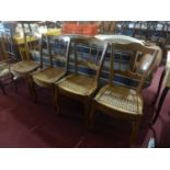 A set of four early 20th century French fruit wood dining chairs