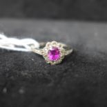 A boxed 1920's 18ct white gold old-cut diamond and pink sapphire cluster ring to diamond-set