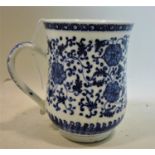An 18th century Chinese blue and white porcelain tankard with floral decoration, H.15 W.16 D.11cm