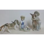 Three Lladro figures, to include a girl picking flowers, H.16cm, a child hugging a donkey, H.21cm,