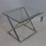 A contemporary lamp table with glass top raised on chrome X frame base, H.48 W.62 D.52cm