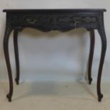 A Continental Georgian style mahogany side table, with two short drawers, on floral carved
