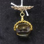 A Victorian 9ct yellow gold fob pendant set with a large faceted citrine to an associated yellow