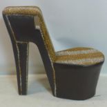 A contemporary chair in the form of a stiletto, with leopard print fabric and leather